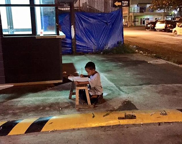 Nine-year-old Filipino pictured studying in the light of a McDonald's